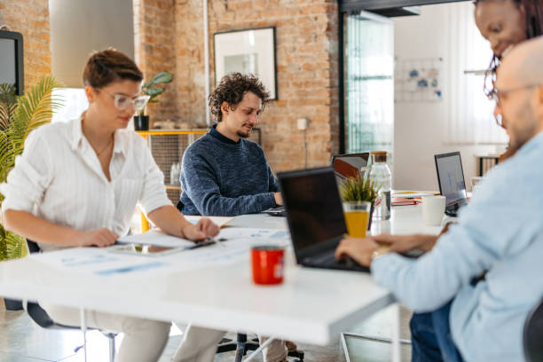 istock Colleagues Working Together In The Office 1465570319