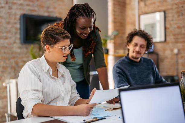 istock Colleagues Consulting With Each Other While Working Together In The Office 1465570653
