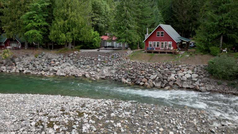 Aerial view of a quaint red cabin overlooking the Skykomish River in Baring, Washington.