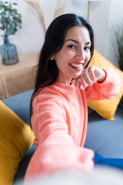 istock Happy woman looking at camera taking a selfie 1465572590