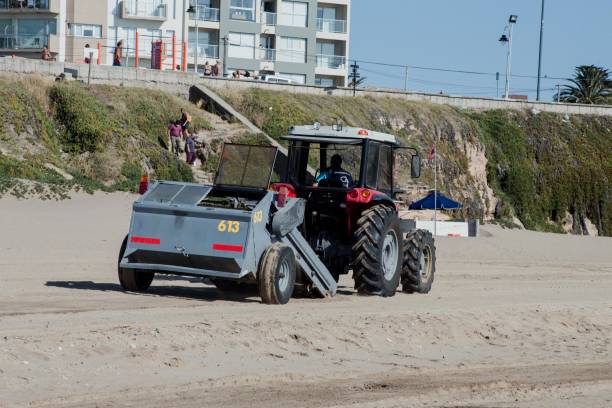 Tractor Refilling With Sand the Beach Tractor Refilling With Sand the Beach constitucion photos stock pictures, royalty-free photos & images