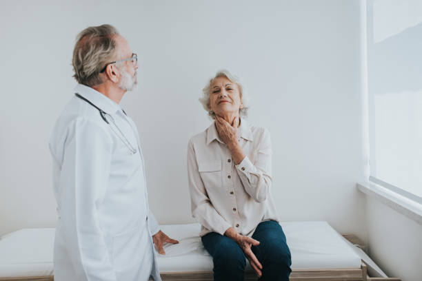 istock Senior patient with sore throat, doctor consultation 1465572948