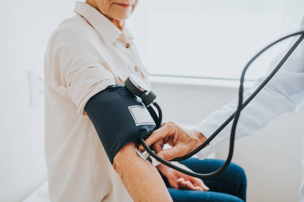 istock Senior patient measuring blood pressure in arm 1465572987