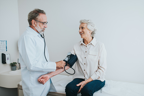 Senior patient measuring blood pressure in arm