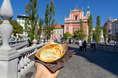 eating traditional slovenian strukelj roll in Ljubljana