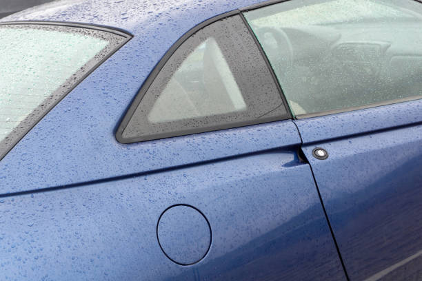 istock The body of a blue car covered with raindrops 1465577238
