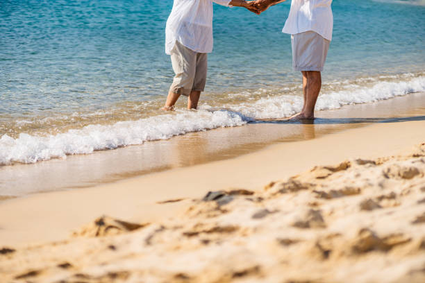 istock Senior Couple Dancing On The Sunny Beach 1465577476