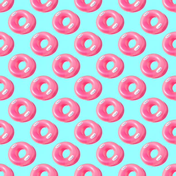 istock Pattern of bright pink inflatable rubber circles on a pale blue background 1465577978