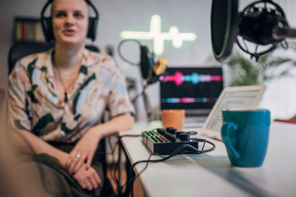 istock Woman in the podcast studio recording a show and talking 1465580265