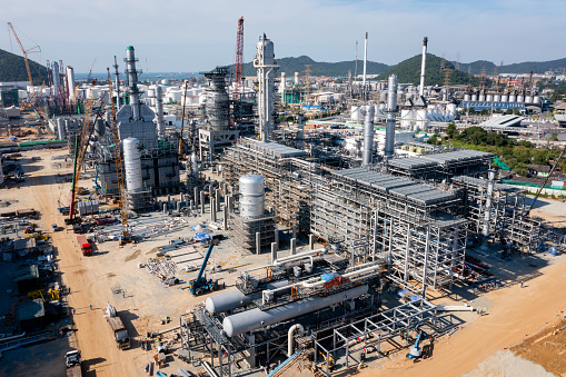 Heavy construction crude oil refinery plants machine doing building with Construction site, aerial view