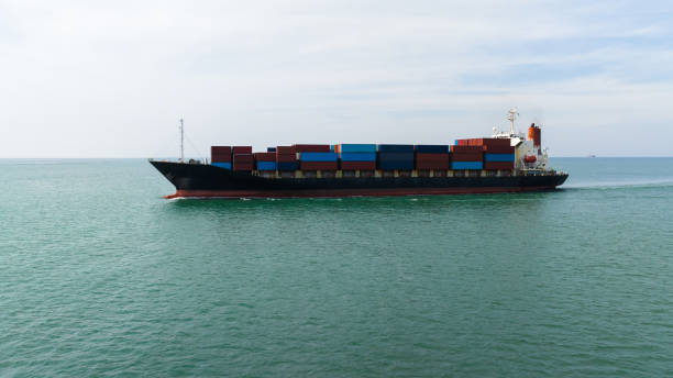 istock containers Commercial shipping port and container ship loading unloading by crane global business and industry services import export transportation international worldwide in sea photograph aerial view from drone 1465580392