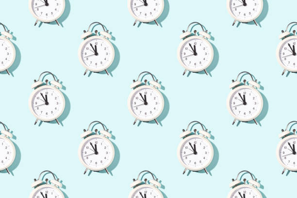 istock Seamless pattern of white alarm clocks. 1465580744