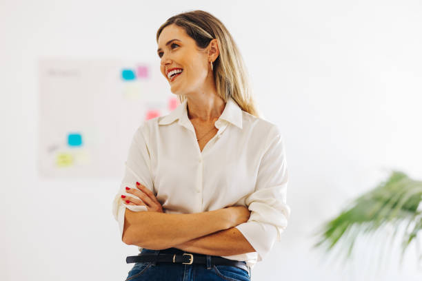 istock Cheerful businesswoman smiling happily in a creative office 1465582911