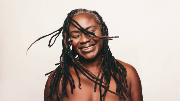 istock Cheerful woman with dreadlocks smiling in a studio 1465584325