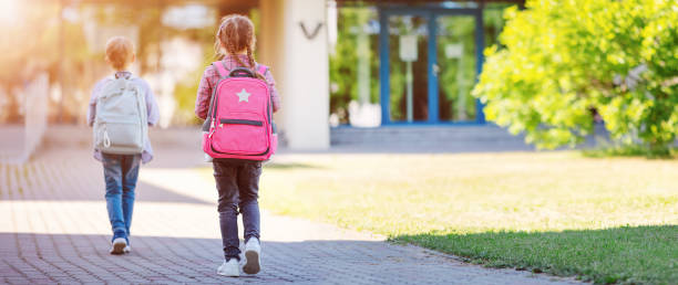 istock Girl and boy going to the school to study at it. 1465585035
