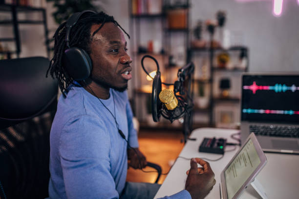istock Man in podcast studio recording a show 1465585099