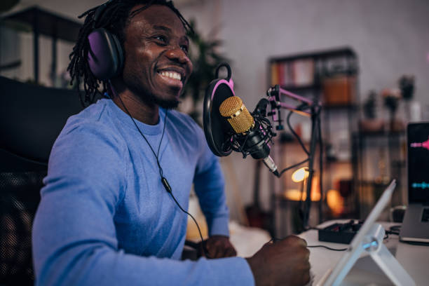 istock Man in podcast studio recording a show 1465585119