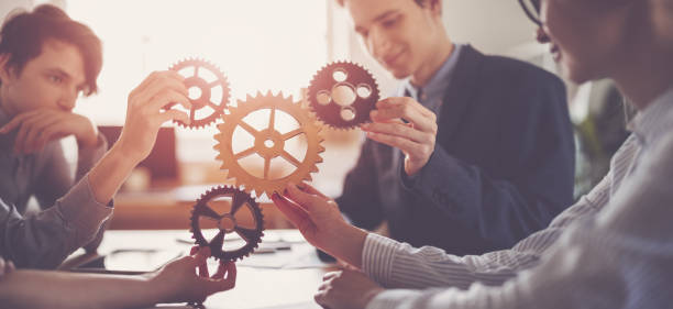 istock Group of people working in the office while putting together cogwheels. 1465585130