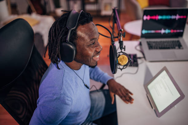 istock Man in podcast studio recording a show 1465585554