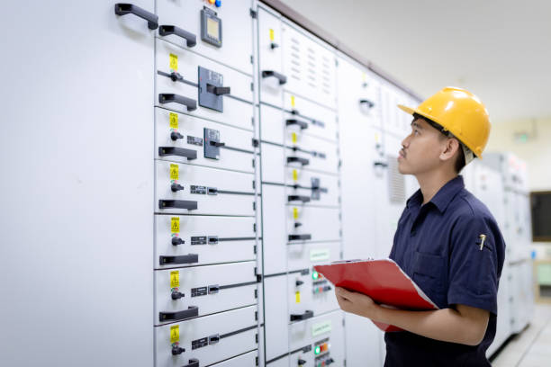 istock Inverter Control Room System Electrical engineers monitor the controller's frequency and current and record the data to the paper in his hand. 1465585766