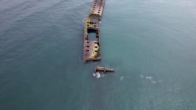 Aerial view of mulberry harbor ocean ruins from WW2 in Normandy France