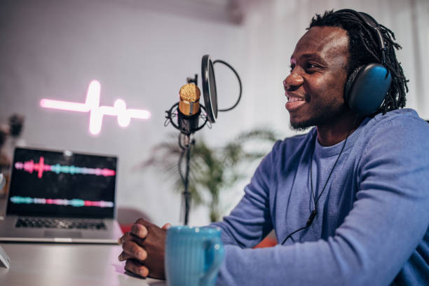 istock Man in podcast studio recording a show 1465587540