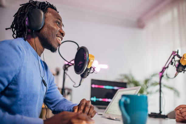 istock Man in podcast studio recording a show 1465589544