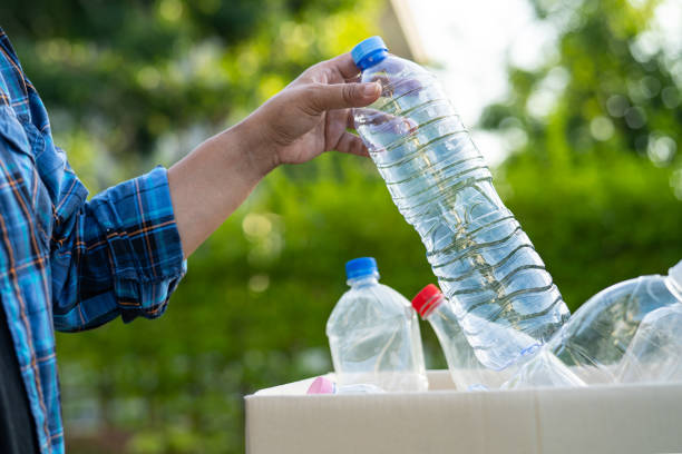istock Woman holding plastic bottles garbage in box to reuse recycle for good environment. 1465592470