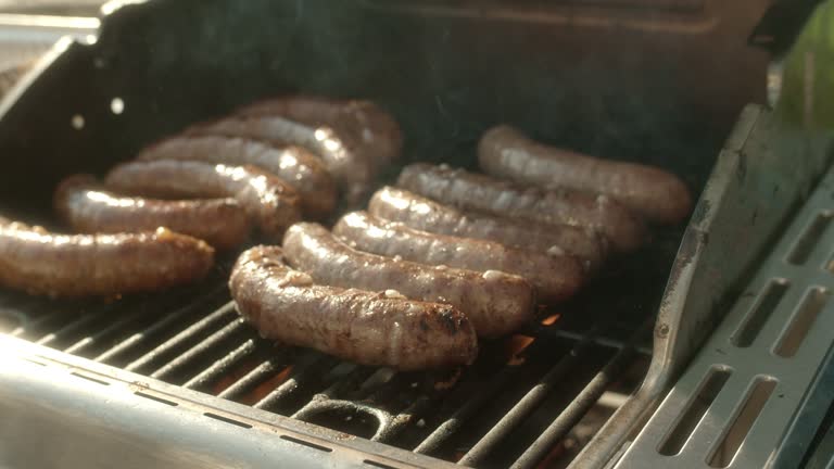 Grilling sausages on backyard barbecue