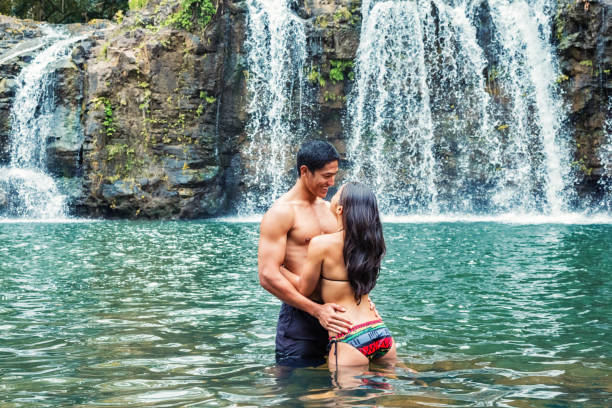 istock Young Couple Sharing a Moment at Remote Hawaiian Waterfall 1465594297