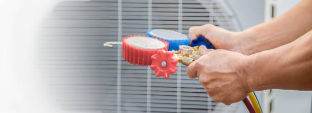 istock Air conditioning, HVAC service technician using gauges to check refrigerant and add refrigerant. 1465595408