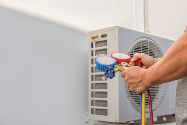 istock Air conditioning, HVAC service technician using gauges to check refrigerant and add refrigerant. 1465595420