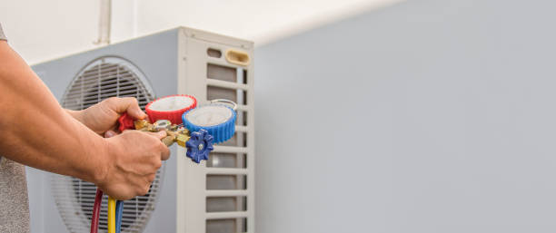 istock Air conditioning, HVAC service technician using gauges to check refrigerant and add refrigerant. 1465595428