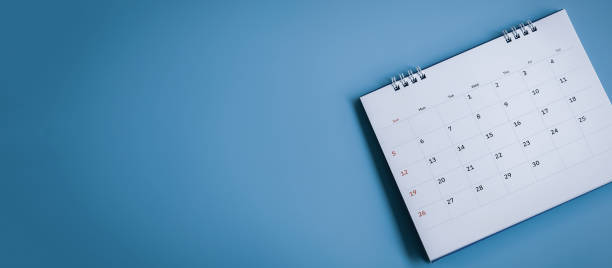 istock White calendar on blue background, planning and schedule concept 1465595519