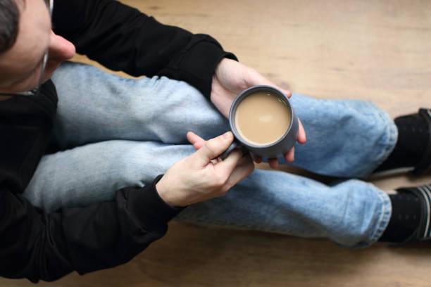 istock a person holds a cup with coffee 1465600162