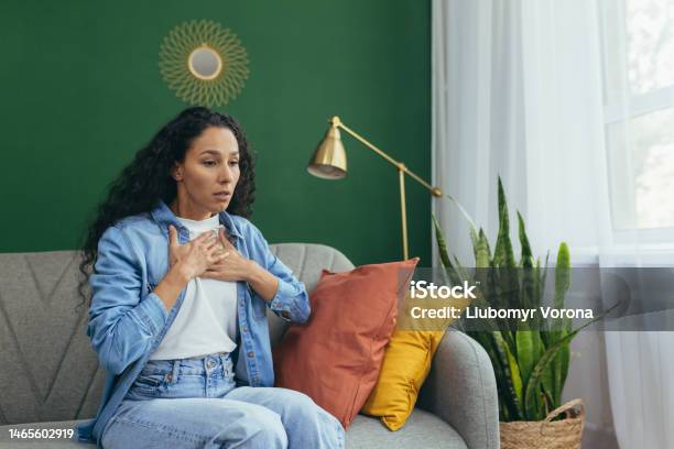 A Latin American Asthmatic Woman Is Experiencing An Asthma Attack Holding His Chest With His Hands Stock Photo - Download Image Now