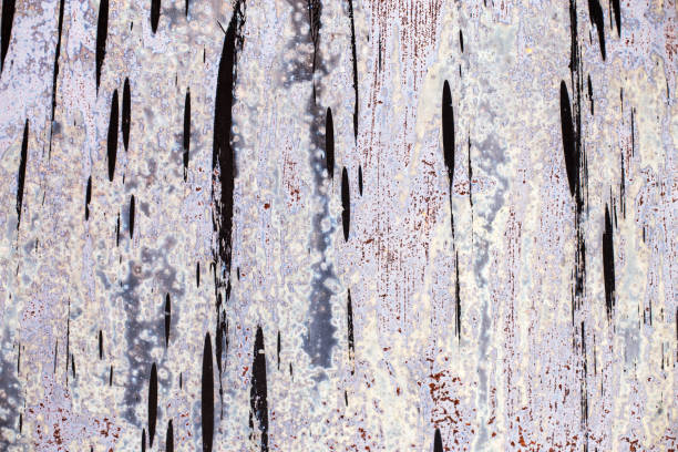 istock Old gray sheet metal smeared with black tar. shabby rusty metal surface. 1465603348