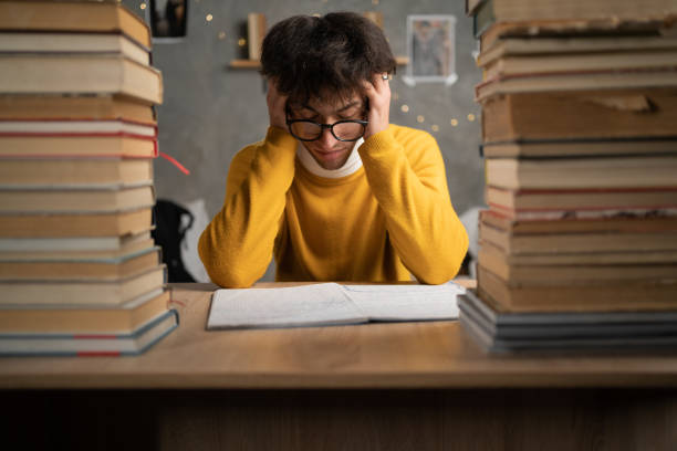 istock Tired student with books preparing for an exam 1465603445