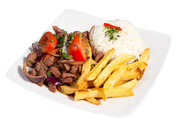 Peruvian traditional food. A beef with tomatoes, onion, rice and fried potatoes, Lomo saltado, isolated on white