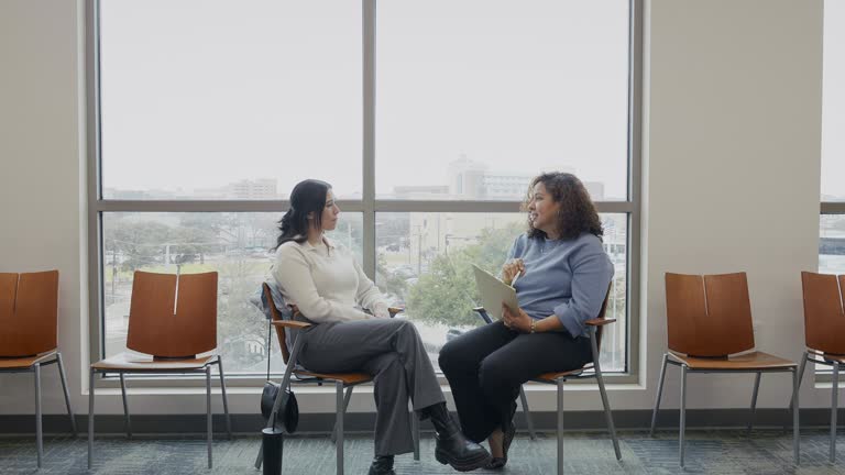 Female therapist and female therapy patient discuss something during session