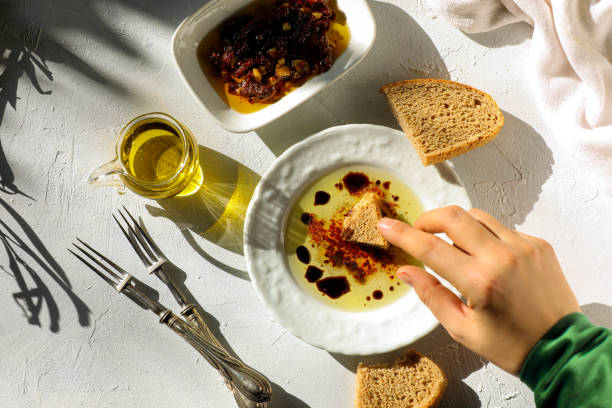 Woman dipping olive oil