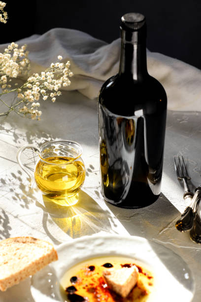Olive oil and bottle of olive oil on white sunny background stock photo