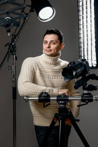 istock Professional handsome photographer with digital camera on tripod 1465606765