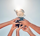 Women, hands or sports trophy in fitness success, workout game or exercise match on summer blue sky. Low angle, team and winner prize cup for school community, training health or wellness award goals