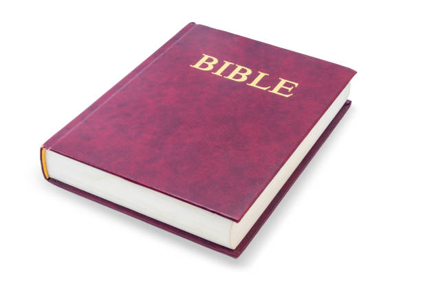 istock Holy bible - lying red closed book, isolated on white with clipping path 1465607882