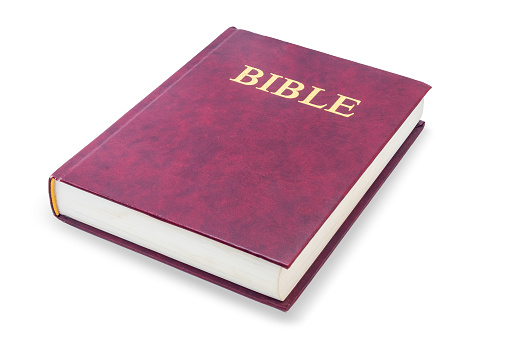 Holy bible - lying red closed book, isolated on white background with clipping path