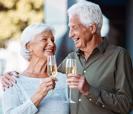 Senior couple, wine and toast outdoor, love or happiness celebration for anniversary or event together. Smile, happy or love with elderly man and woman with alcohol glass to celebrate and marriage