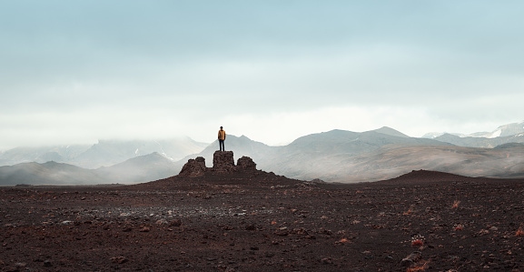 Man standing on top of the rock in Icelandic highlands. Panoramic view.