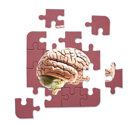 Jigsaw of a brain on a burgundy background.