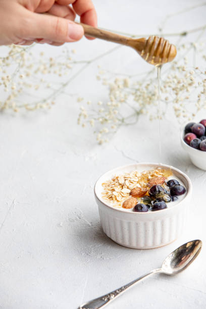 istock Yogurt bowl with oatmeal, almonds, blueberries and honey. 1465612297
